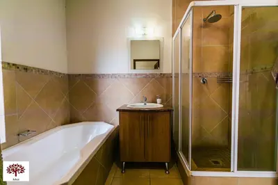 a bathroom with a tub and a sink and a shower at Zebula Golf and Wildlife Estate - Spectacular View Pax 13 - Moi Signature Luxury villa in Mabula