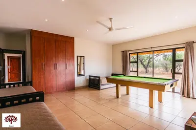 a living room with a pool table in it at Zebula Golf and Wildlife Estate - Spectacular View Pax 13 - Moi Signature Luxury villa in Mabula