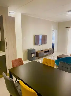a large living room with a table and chairs at Blest5 Tranquil Stay in Midrand