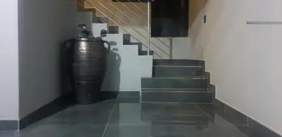 a hallway with stairs with a large metal barrel at The Concept in Centurion