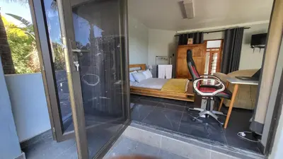 a bedroom with a bed and a desk and a chair at The Concept in Centurion