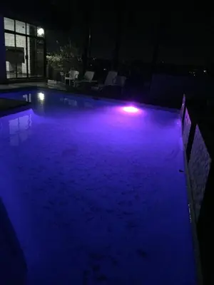 a swimming pool with blue lights in the dark at The Concept in Centurion