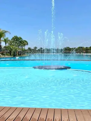 a fountain in the middle of a swimming pool at The Blyde Crystal Lagoon in Pretoria