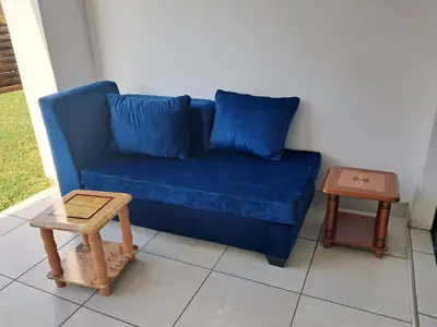 a blue couch and a table in a room at The Blyde Crystal Lagoon in Pretoria