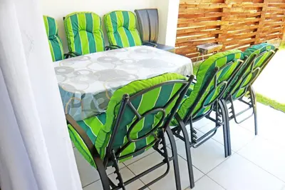 a table with green chairs and a table and a table and chairsearcher at The Blyde Crystal Lagoon in Pretoria