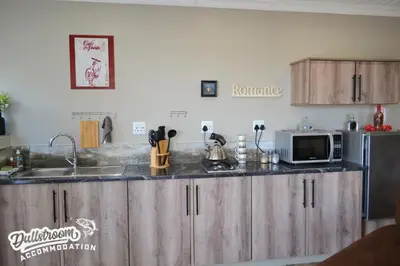 a kitchen with a counter top with a microwave at Misty View Apartments in Dullstroom