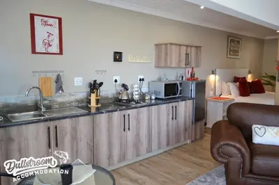 a kitchen with a sink and a microwave at Misty View Apartments in Dullstroom