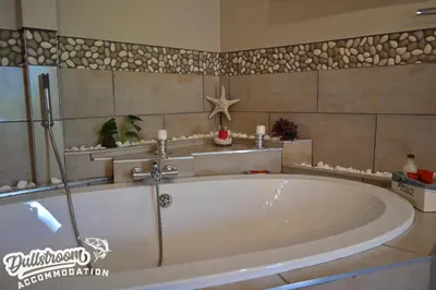 a large bath tub in a bathroom at Misty View Apartments in Dullstroom