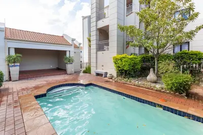 a swimming pool in front of a house at Budget-Friendly & Cozy Haven by BK Hospitable in Midrand