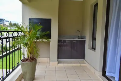 a balcony with a sink and a plant at Candymore luxury apartment in Midrand
