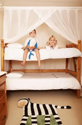 two children sitting on top of a bed at Jembisa Bush Home in Melk River