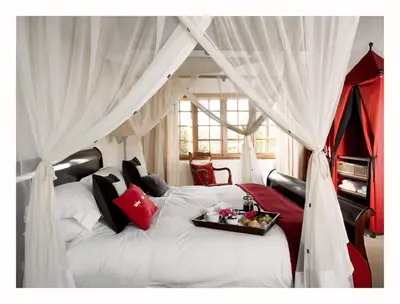 a bedroom with a white bed with a tray on it at Jembisa Bush Home in Melk River