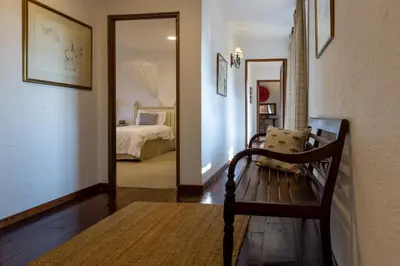 a room with a bench and a bedroom with a bed at Jembisa Bush Home in Melk River