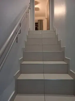 a stairway with white stairs and a hallway at 3 bedroom self catering @ Lelapa La Baphogole in Pretoria