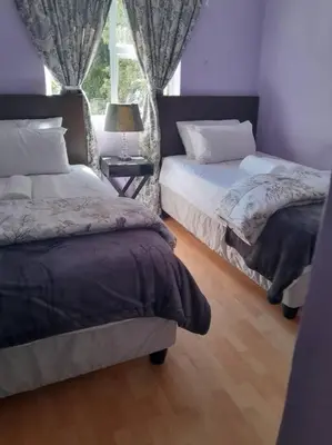 a bedroom with two beds and a window at 3 bedroom self catering @ Lelapa La Baphogole in Pretoria