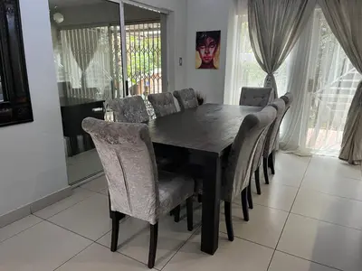 a dining room with a table and chairs at 3 bedroom self catering @ Lelapa La Baphogole in Pretoria