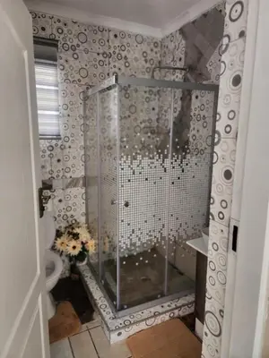 a shower stall in a bathroom with a toilet at 17 Byvanger Luxury Home Deluxe Queen Suite Room 1 in Centurion