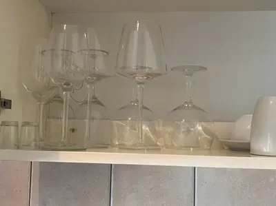 a row of wine glasses sitting on a shelf at Executive suite@Lofts in Pretoria