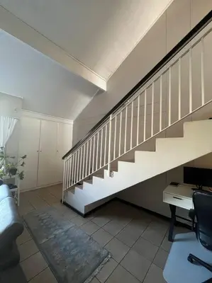 a staircase in a room with a table and a desk at Executive suite@Lofts in Pretoria