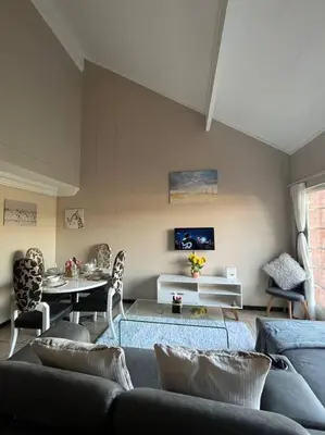 a living room with a couch and a table at Executive suite@Lofts in Pretoria