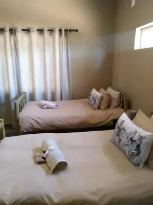 two beds in a room with towels on them at Marocco Lodge in Baltimore