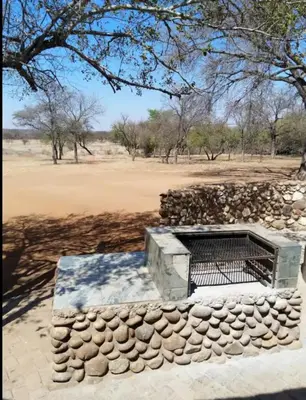 a stone wall with a bench in front of a field at Marocco Lodge in Baltimore