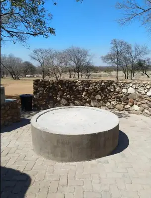 a stone bench in front of a stone wall at Marocco Lodge in Baltimore