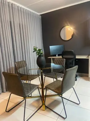 an office with a table and chairs and a mirror at Green Valley Bliss in Boschrand