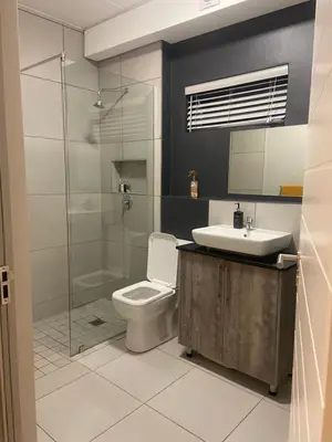 a bathroom with a toilet and a sink and a shower at Green Valley Bliss in Boschrand