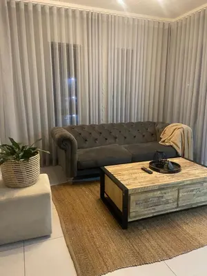 a living room with a couch and a coffee table at Green Valley Bliss in Boschrand