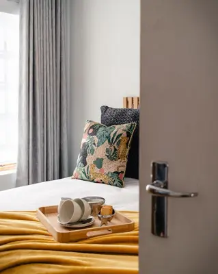 a bed with a tray with dishes on it at The Lofts @ Ivy Lane in Dullstroom