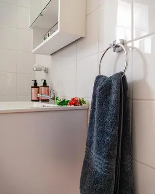a bathroom with a blue towel hanging on a rack at The Lofts @ Ivy Lane in Dullstroom