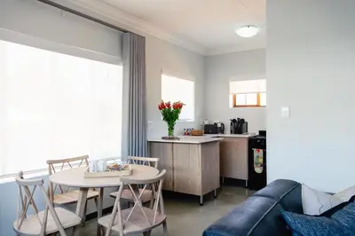 a living room with a couch and a table at The Lofts @ Ivy Lane in Dullstroom