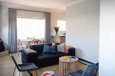 a living room with a couch and a table at The Lofts @ Ivy Lane in Dullstroom
