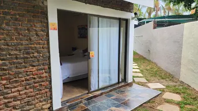 a glass door leading to a bedroom with a bed at SABLE INN B&B in Modimolle