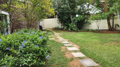 a garden with a stone path in a yard at SABLE INN B&B in Modimolle