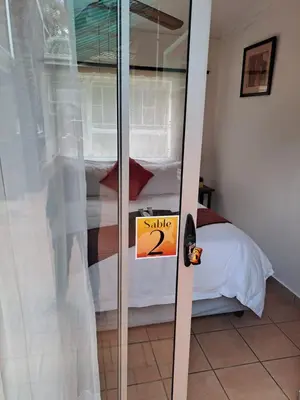 a sliding glass door with a sign that says sale at SABLE INN B&B in Modimolle