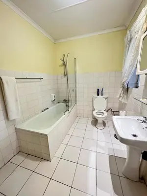 a bathroom with a tub and a toilet and a sink at Limpopo Guest Manor in Polokwane