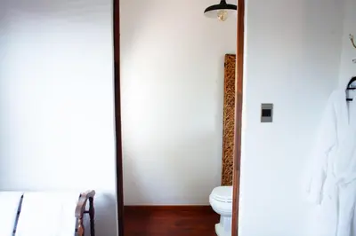 a bathroom with a toilet and a mirror at The Blue Place in Pretoria