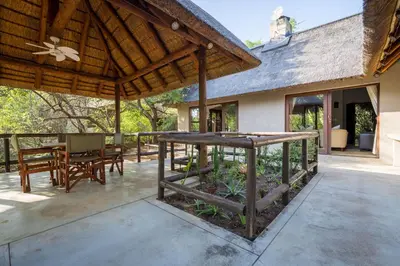 an outdoor patio with a table and chairs at Raptors Lodge in Hoedspruit