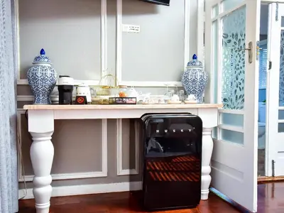 a microwave oven sitting under a table in a room at C'est La Vie Boutique Hotel in Witbank