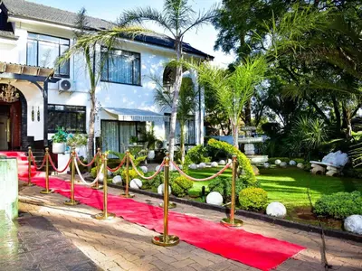 a red carpet in front of a house at C'est La Vie Boutique Hotel in Witbank