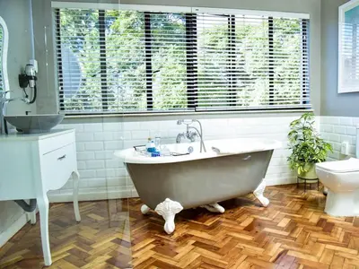 a bathroom with a large tub and a toilet at C'est La Vie Boutique Hotel in Witbank