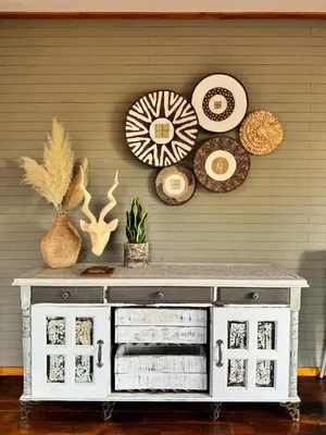 a white cabinet with several plates on a wall at Sonbesie in Marloth Park