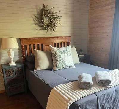 a bedroom with a bed with towels on it at Sonbesie in Marloth Park