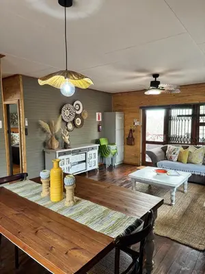 a living room with a table and a couch at Sonbesie in Marloth Park