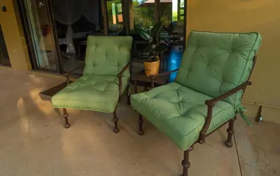two green chairs and a table in a room at Bee-Eater Cottage in Hoedspruit