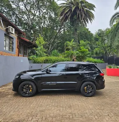 a black car parked in front of a house at Marandela Guesthouse in Louis Trichardt