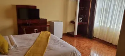 a bedroom with a bed and a television in a room at Marandela Guesthouse in Louis Trichardt