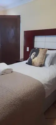 a bedroom with a bed with a pillow on it at Marandela Guesthouse in Louis Trichardt